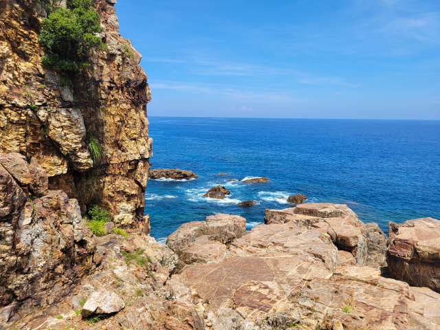 The sheer cliffs and blue sea as seen from Crystal Cape on Yakushima